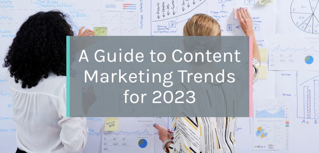 A marketing team drawing on a whiteboard with the words "A Guide to Content Marketing Trends in 2023" over them.