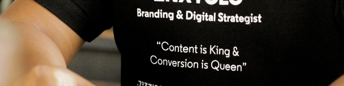 Close up of t-shirt with the wordas "Branding & Digital Strategist, Content is King & Conversion is Queen"